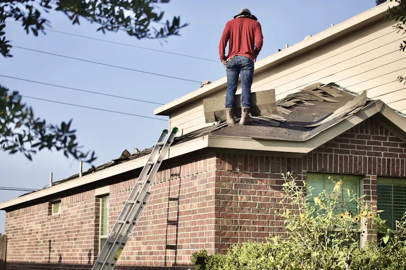 Professional roofer working on a residential roof in Sugarland Run